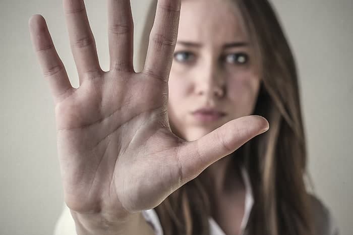 Woman holding up her hand in a stop gesture